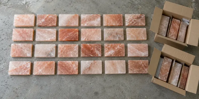Pink Himalayan salt bricks dry-laid on a floor to balance light and dark shades before installation